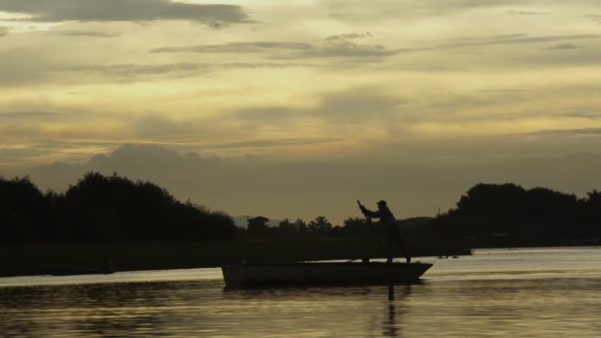 Indigenous man paddling his canoe in South America