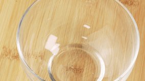 Roasted coffee beans falling into glass bowl rotating on wooden table in slow motion. Coffee beans falling into bowl on wooden background. Coffee shop backdrop - Powered by Shutterstock - Get 15% off with code: PIKWIZARD15