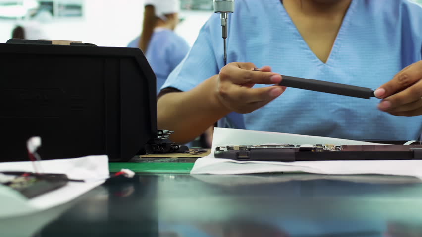 Female Workers Installing Hardware on Laptop Assembly Line - Close Up - 4K