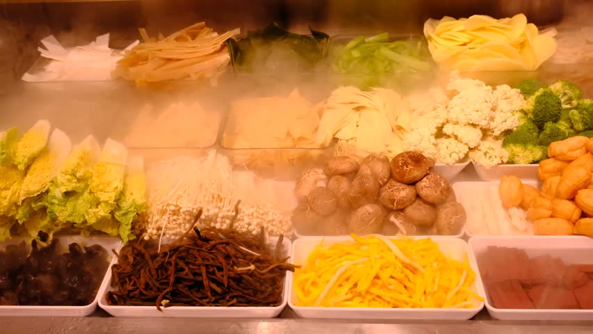 fresh fruit and vegetable casseroles in dry ice smoke clouds fog at the market in Chongqing, China