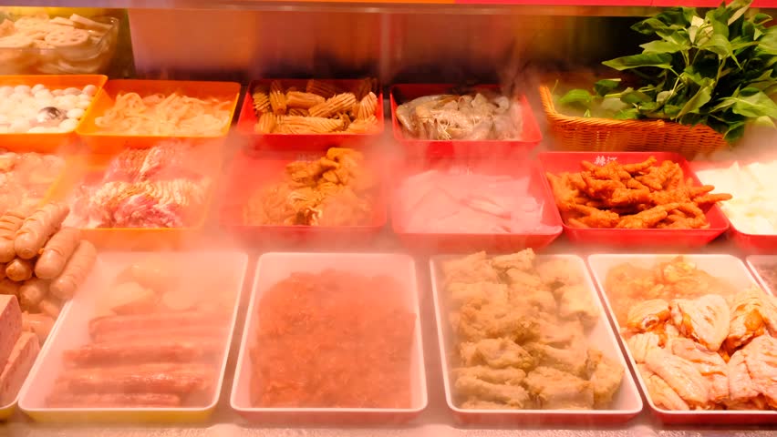 fresh fruit and vegetable casseroles in dry ice smoke clouds fog at the market in Chongqing, China