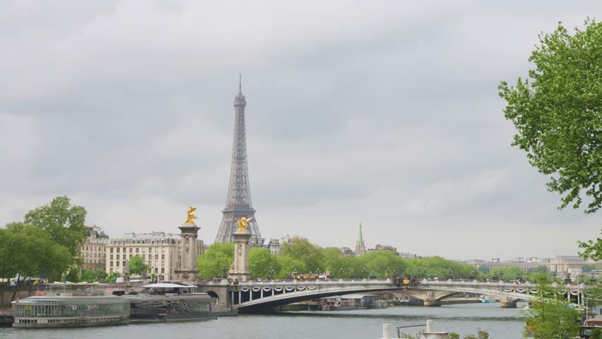 View of the the Pont Alexandre III bridge over the Seine River and the House of Invalides from the right bank in Paris, France.