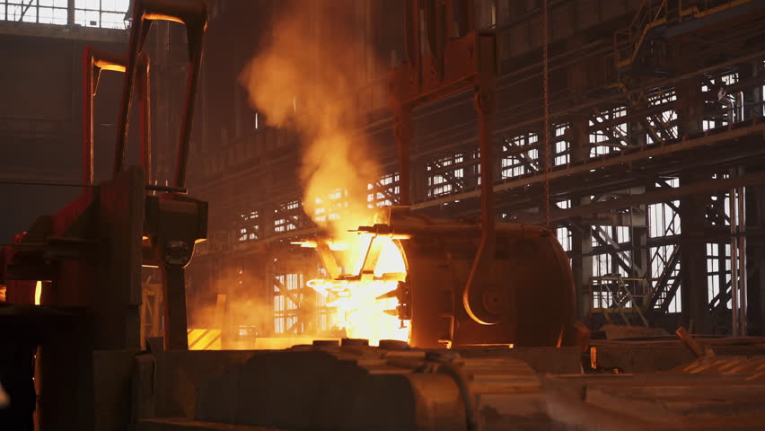Molten metal pouring in steel mill montage. Stock clip