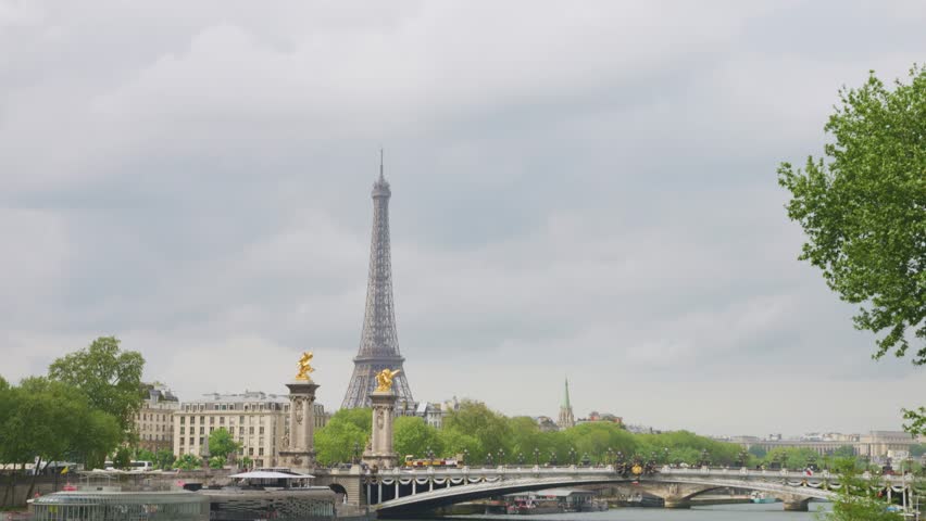 View of the Seine River, the Alexandre III Bridge and the Eiffel Tower from the right bank of the river in Paris, France.