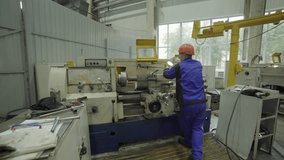 Factory worker operating lathe machine manufacturing metal part. Stock clip - Powered by Shutterstock - Get 15% off with code: PIKWIZARD15