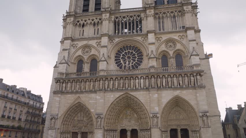 View on the medieval Catholic cathedral church Notre-Dame de Paris in French Gothic style at the Place Jean-Paul II on the island Ile de la Cite, 4th arrondissement of Paris, France.