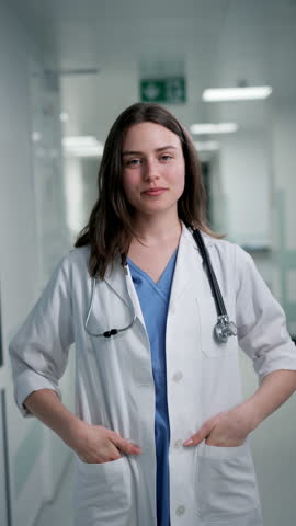Smiling young female doctor in hospital.