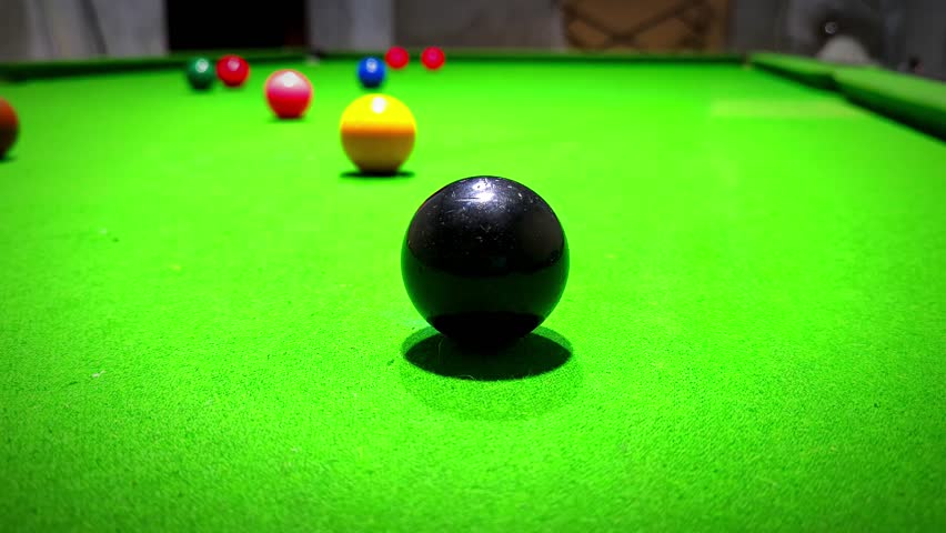 A close-up shot of snooker balls on a green table, ready for a game of pool. Indoor sport and recreation.