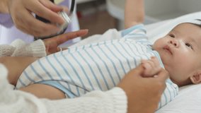 Asian loving mother comforts her three-month-old, as a male doctor administers essential childhood vaccinations, ensuring the baby's healthy future in a calm, professional setting. - Powered by Shutterstock - Get 15% off with code: PIKWIZARD15