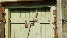 Heavy chain, rusted lock secure aged wooden doors in abandoned Soviet structure - Powered by Shutterstock - Get 15% off with code: PIKWIZARD15