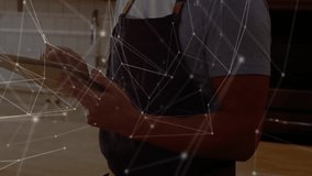 Male chef tapping tablet screen and activating network overlay while consulting kitchen space. Technology, innovation, culinary, gourmet, modern, professional, connectivity - Powered by Shutterstock - Get 15% off with code: PIKWIZARD15