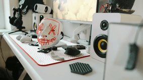 Cyberpunk mask stands on gaming desk surrounded by modern accessories and computer screen. Concept of anonymity and futuristic tech identity in online culture. - Powered by Shutterstock - Get 15% off with code: PIKWIZARD15