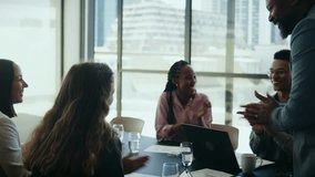 Team of diverse business professionals applauding in boardroom in office during daytime - Powered by Shutterstock - Get 15% off with code: PIKWIZARD15