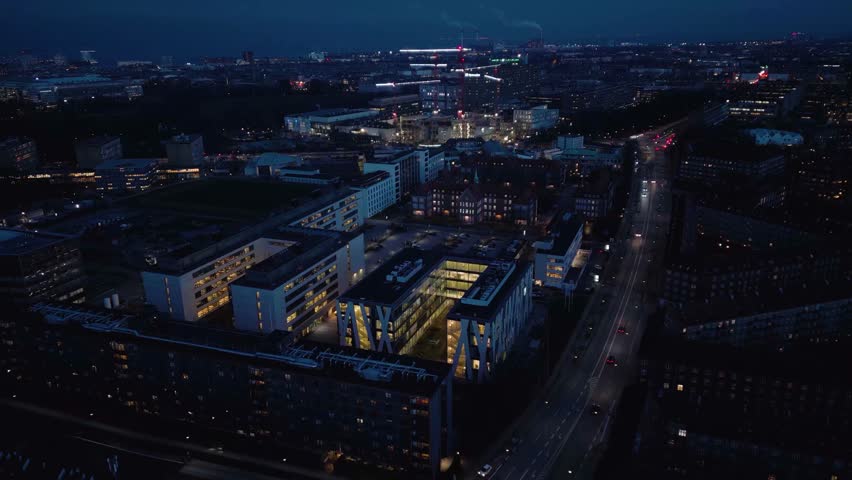 Copenhagen city night pan down aerial with bright lights