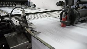 folding machine folds printed offset sheet as part of newspaper brochure in print house