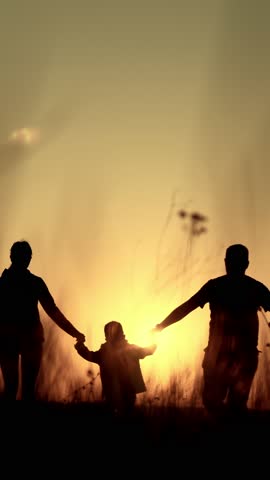 Happy childhood moments, little boy walking in nature with mom and dad, back view, silhouette. Family time in summer vacation and holidays, admiring beautiful sunset or sunrise, slow motion shot
