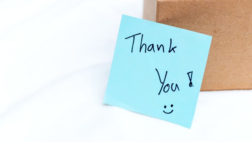 Zoom in gratitude thank you note a gift box home setting intimate perspective