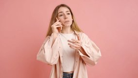 Blonde woman wearing casual clothes engages in various phone conversations, displaying a range of emotions and gestures against a vibrant pink backdrop - Powered by Shutterstock - Get 15% off with code: PIKWIZARD15