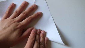 Folding a paper origami white crane, close-up. DIY concept - Powered by Shutterstock - Get 15% off with code: PIKWIZARD15