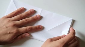 Folding a paper origami white crane, close-up. DIY concept - Powered by Shutterstock - Get 15% off with code: PIKWIZARD15