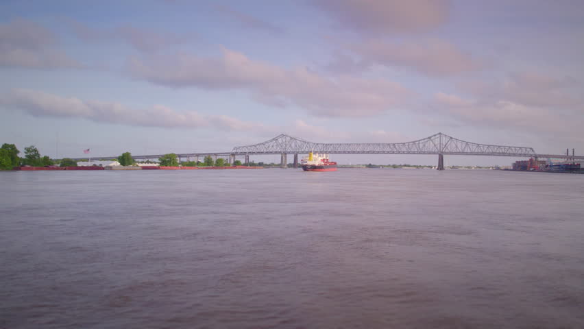 Drone across water towards tanker ship on the Mississippi River