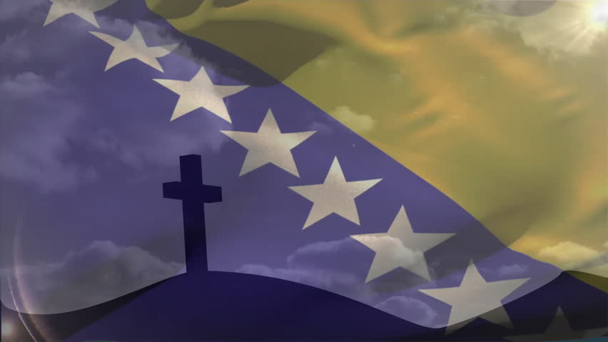 Flag fading in and waving over cross, clouds drifting and sunbeams shining evoking dawn remembrance. Monument, patriotism, symbolism, nature, serenity, spirituality, landscape