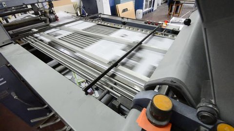 folding machine HD CRANE SHOOT folds printed offset sheet as part of newspaper brochure in print house