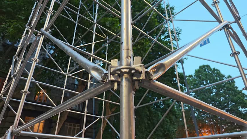 Metal scaffolding tower structure growing tall section by section
