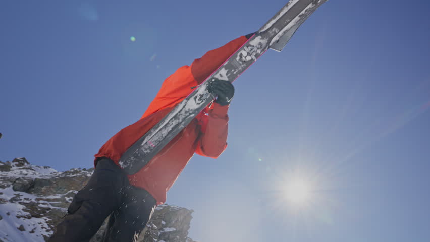 A professional skier hikes up a steep ridge in Verbier, then drops into an epic freeride descent. Pure adventure skiing in deep snow, dramatic terrain, and breathtaking alpine scenery.