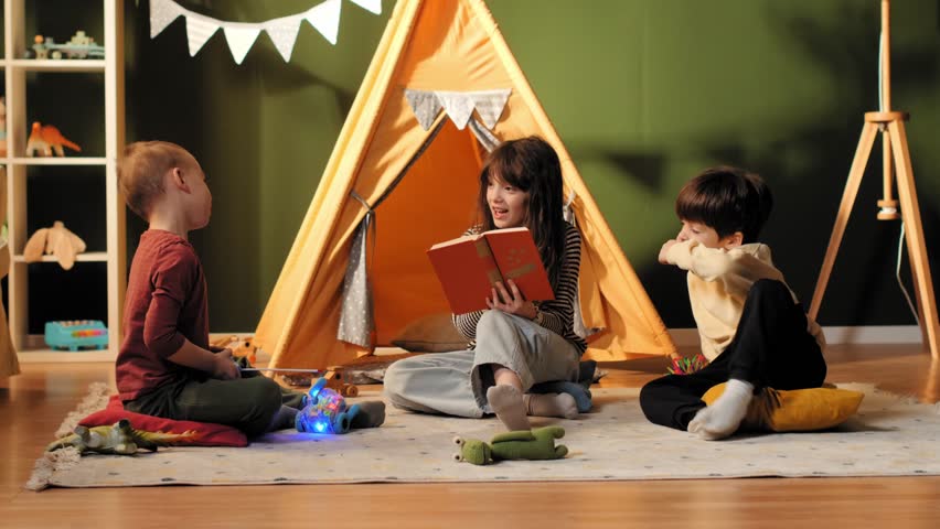 Kids enjoying storytelling and imaginative play inside a teepee tent in a playroom