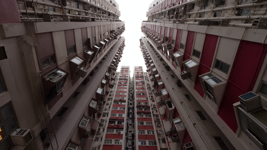Low angle view of old residential buildings in Kennedy Town, Hong Kong, showcasing dense urban housing and retro high-rise concrete architecture. Typical yet impressive view