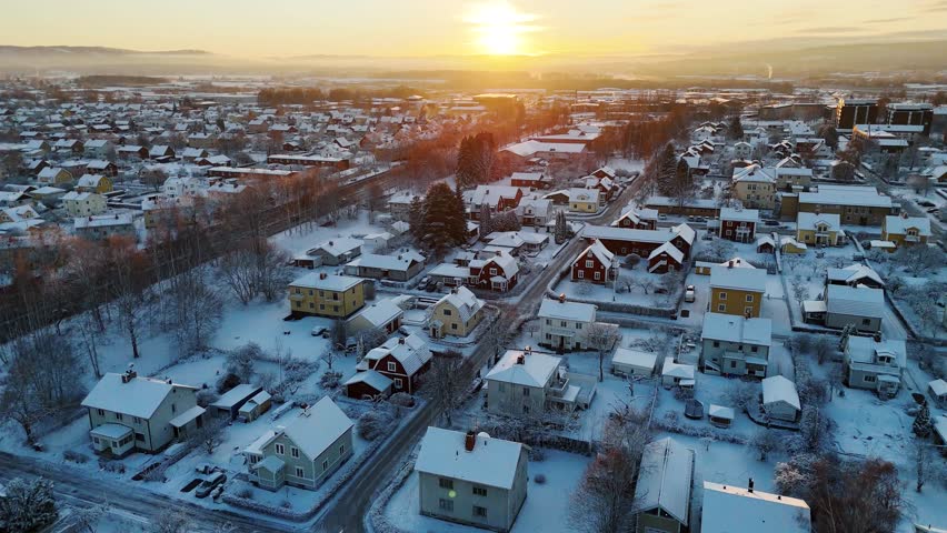Snow-covered suburb area in Borlange, Sweden during winter at sunset