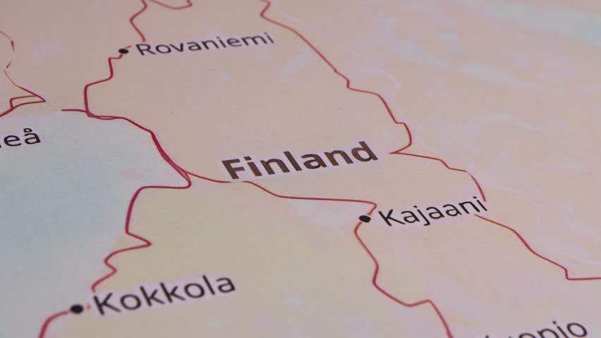 Close-up of a red pushpin marking the location of Finland as part of a travel destination
