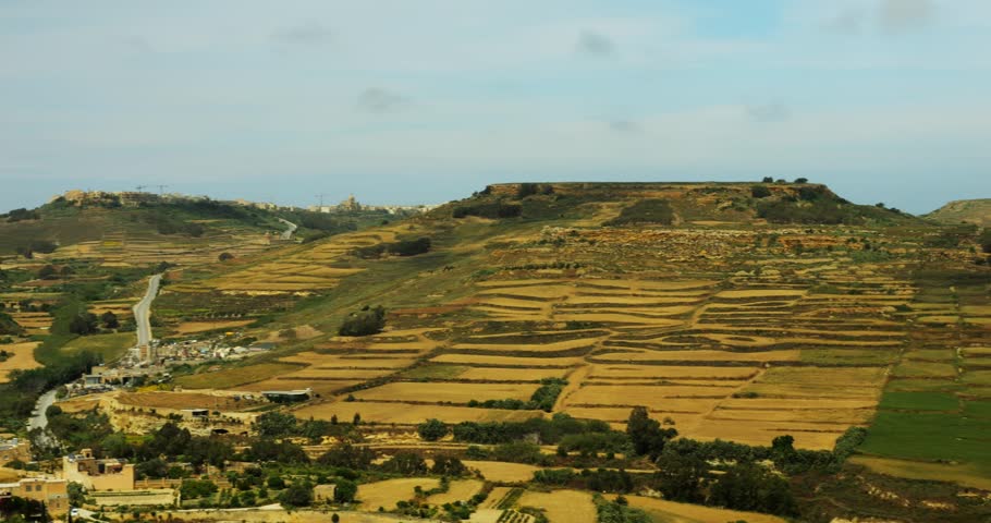 Spacious hilly area contains shrubs and slopes with views of Mediterranean Sea. Small Gozo Island offers cultural and farm sites near city of Victoria