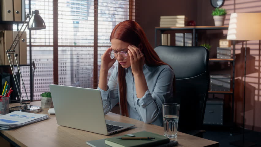 Caucasian woman businesswoman girl female business manager employer ill sick tired exhausted medicine health problem painkiller feel suffer headache pain head migraine ache working laptop at office