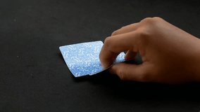 slow motion. hand opening cards. peeking at poker cards. pair of poker cards. playing poker cards with dark background - Powered by Shutterstock - Get 15% off with code: PIKWIZARD15