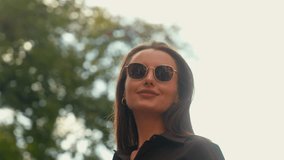 Attractive girl model woman put on sunglasses in street. Portrait stylish female in trendy glasses outdoors in sunny day fashion concept confident businesswoman business lady smiling in city headshot - Powered by Shutterstock - Get 15% off with code: PIKWIZARD15