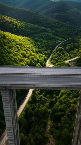 Aerial View of Transportation Truck Driving on Scenic Mountain Bridge in Bulgaria Vertical