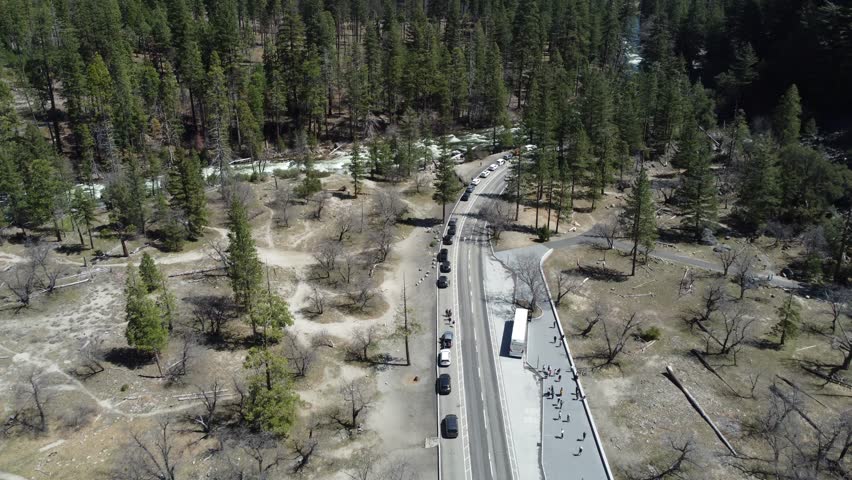 Fresh Spring Snowmelt Rushing Down The Scenic Wilderness Of Yosemite National Park, California, USA. Cars And Bikes Lined Up In The Heart Of Yosemite Valley.