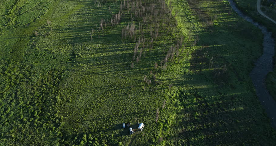 Tilting drone shot of a meadow near Shadow Mountain Lake at sunrise in the Rocky Mountains of Colorado