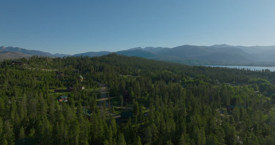 Orbiting drone shot of Shadow Mountain Lake at sunrise in the Rocky Mountains of Colorado