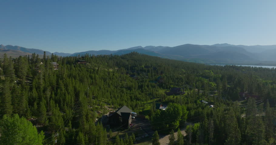 Orbiting drone shot of Shadow Mountain Lake at sunrise in the Rocky Mountains of Colorado