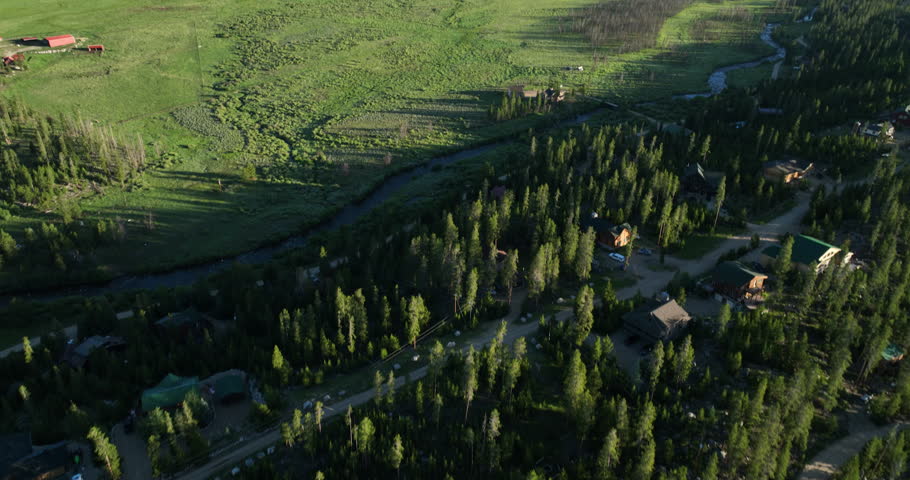 Tilting drone shot of a meadow near Shadow Mountain Lake at sunrise in the Rocky Mountains of Colorado