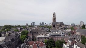 Aerial of gothic cathedral nave and De Dom church tower architecture among historic buildings in Utrecht city center. Dutch Holland religious tourist destination seen from above. - Powered by Shutterstock - Get 15% off with code: PIKWIZARD15