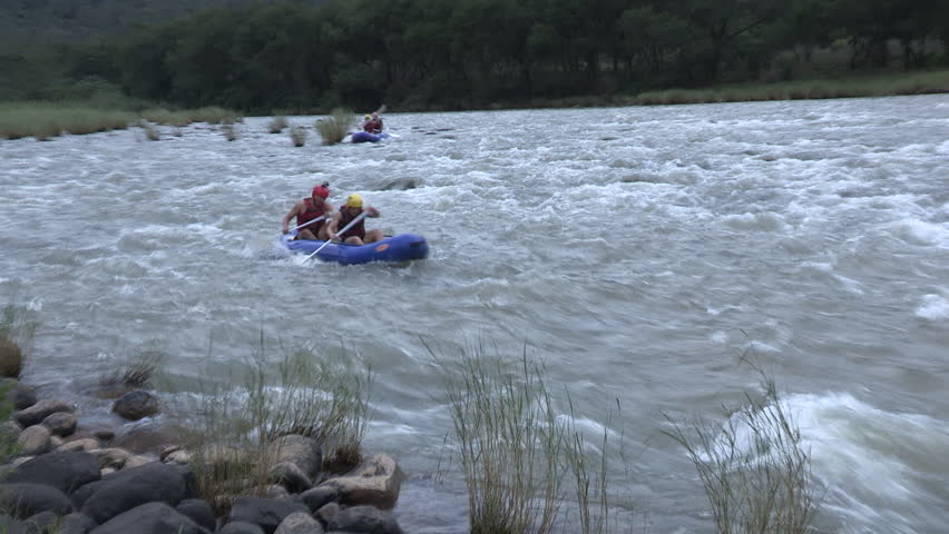 Two young male rafters white water rafting in the rough Umkomaas river 