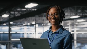 Happy woman in data center doing maintenance tasks on laptop, ensuring optimal performance. Engineering team reviewing diagnostics and applying patches to server room, improving stability, camera B - Powered by Shutterstock - Get 15% off with code: PIKWIZARD15