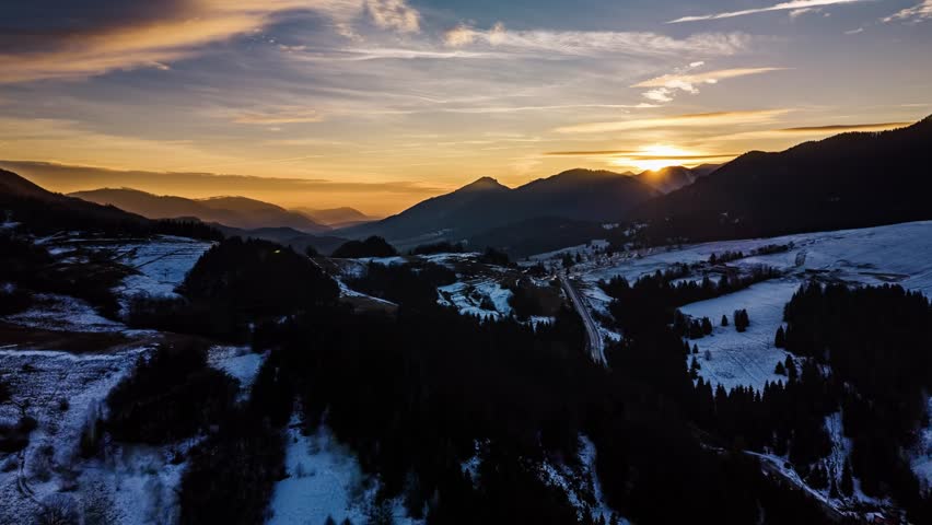 Aerial view of Golden Sunrise Over Rural Landscape with Melting Snow in Early Spring