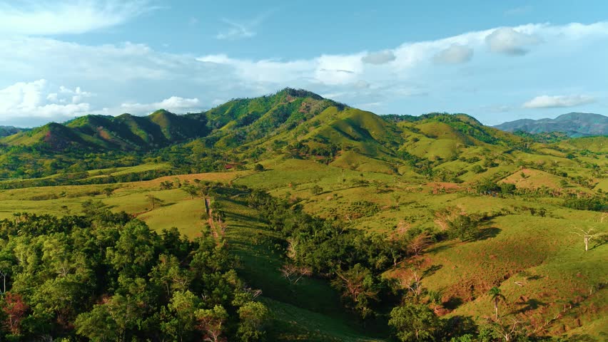 Green mountain valley in Latin America in the morning light. Panorama of beautiful wild nature of Dominican Republic. Amazing mountain landscape. World of beauty. Concept of freshness of nature.