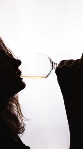 Woman drinking wine on white background. Shadow silhouette of female person celebrating holiday in bar. Romantic evening. 