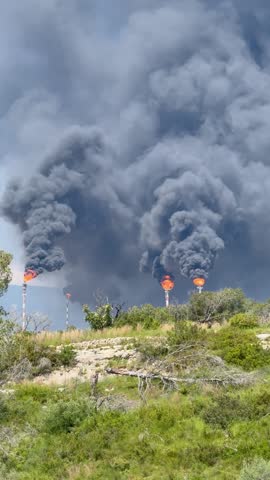 Black smoke from a chimney at a chemical plant. Environmental pollution emissions of harmful substances into the atmosphere.